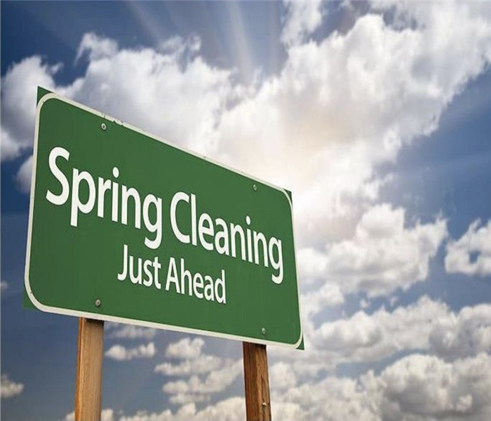 a road sign that reads "spring cleaning ahead"