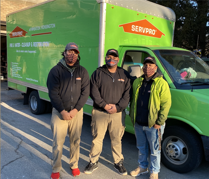 3 Men standing in front of a service truck